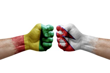 Two hands punch to each others on white background. Country flags painted fists, conflict crisis concept between guinea and nepal
