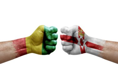 Two hands punch to each others on white background. Country flags painted fists, conflict crisis concept between guinea and ireland