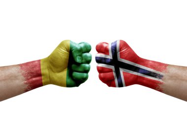 Two hands punch to each others on white background. Country flags painted fists, conflict crisis concept between guinea and norway