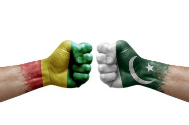 Two hands punch to each others on white background. Country flags painted fists, conflict crisis concept between guinea and pakistan