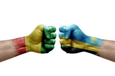 Two hands punch to each others on white background. Country flags painted fists, conflict crisis concept between guinea and rwanda