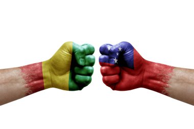 Two hands punch to each others on white background. Country flags painted fists, conflict crisis concept between guinea and samoa