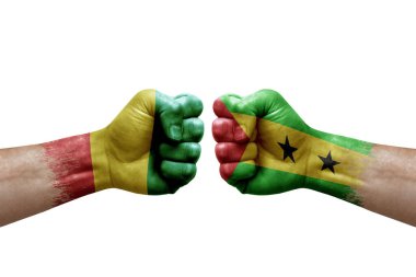 Two hands punch to each others on white background. Country flags painted fists, conflict crisis concept between guinea and sao tome and principe