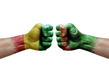 Two hands punch to each others on white background. Country flags painted fists, conflict crisis concept between guinea and turkmenistan