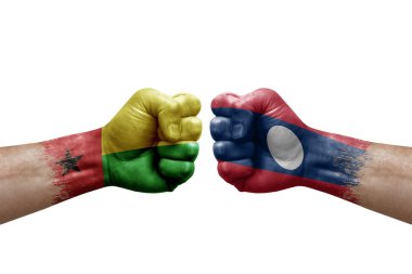 Two hands punch to each others on white background. Country flags painted fists, conflict crisis concept between guinea-bissau and laos