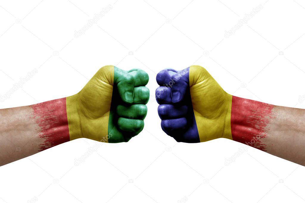 Two hands punch to each others on white background. Country flags painted fists, conflict crisis concept between guinea and romania