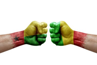 Two hands punch to each others on white background. Country flags painted fists, conflict crisis concept between guinea-bissau and mali