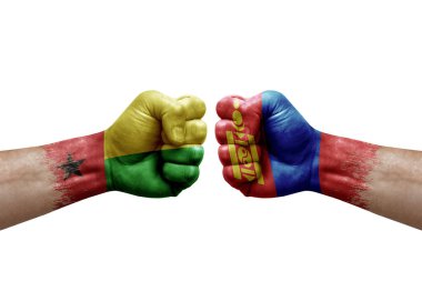 Two hands punch to each others on white background. Country flags painted fists, conflict crisis concept between guinea-bissau and mongolia