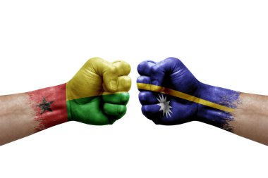 Two hands punch to each others on white background. Country flags painted fists, conflict crisis concept between guinea-bissau and nauru