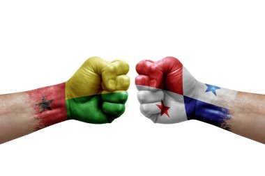 Two hands punch to each others on white background. Country flags painted fists, conflict crisis concept between guinea-bissau and panama