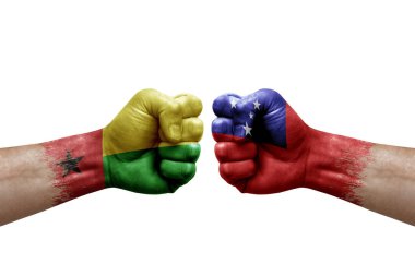 Two hands punch to each others on white background. Country flags painted fists, conflict crisis concept between guinea-bissau and samoa