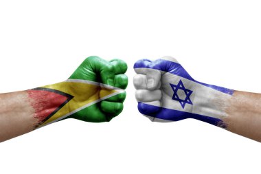 Two hands punch to each others on white background. Country flags painted fists, conflict crisis concept between guyana and israel