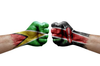 Two hands punch to each others on white background. Country flags painted fists, conflict crisis concept between guyana and kenya