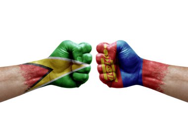Two hands punch to each others on white background. Country flags painted fists, conflict crisis concept between guyana and mongolia