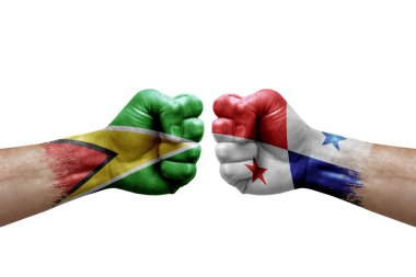 Two hands punch to each others on white background. Country flags painted fists, conflict crisis concept between guyana and panama