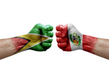 Two hands punch to each others on white background. Country flags painted fists, conflict crisis concept between guyana and peru