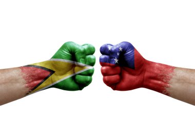 Two hands punch to each others on white background. Country flags painted fists, conflict crisis concept between guyana and samoa