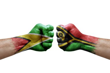 Two hands punch to each others on white background. Country flags painted fists, conflict crisis concept between guyana and vanuatu