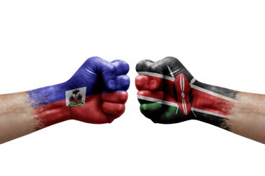 Two hands punch to each others on white background. Country flags painted fists, conflict crisis concept between haiti and kenya