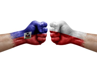 Two hands punch to each others on white background. Country flags painted fists, conflict crisis concept between haiti and poland