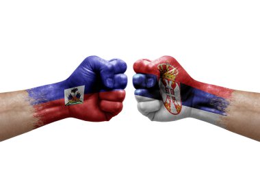Two hands punch to each others on white background. Country flags painted fists, conflict crisis concept between haiti and serbia