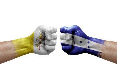 Two hands punch to each others on white background. Country flags painted fists, conflict crisis concept between holy see and honduras