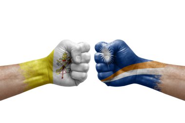 Two hands punch to each others on white background. Country flags painted fists, conflict crisis concept between holy see and marshall islands