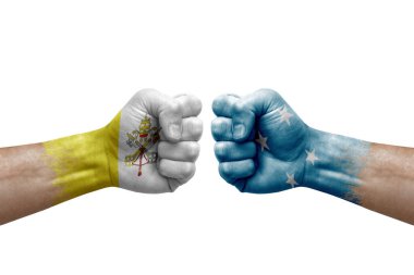 Two hands punch to each others on white background. Country flags painted fists, conflict crisis concept between holy see and micronesia