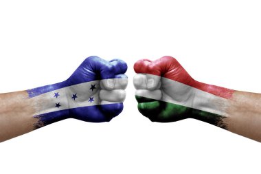 Two hands punch to each others on white background. Country flags painted fists, conflict crisis concept between honduras and hungary