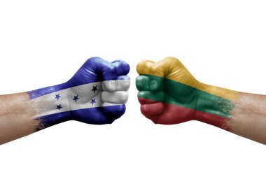 Two hands punch to each others on white background. Country flags painted fists, conflict crisis concept between honduras and lithuania