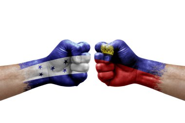 Two hands punch to each others on white background. Country flags painted fists, conflict crisis concept between honduras and liechtenstein