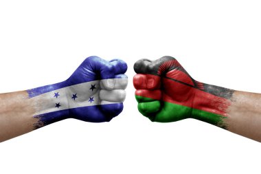 Two hands punch to each others on white background. Country flags painted fists, conflict crisis concept between honduras and malawi