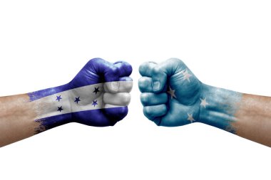 Two hands punch to each others on white background. Country flags painted fists, conflict crisis concept between honduras and micronesia
