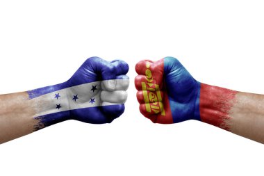 Two hands punch to each others on white background. Country flags painted fists, conflict crisis concept between honduras and mongolia