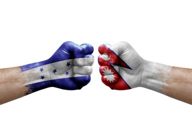 Two hands punch to each others on white background. Country flags painted fists, conflict crisis concept between honduras and nepal