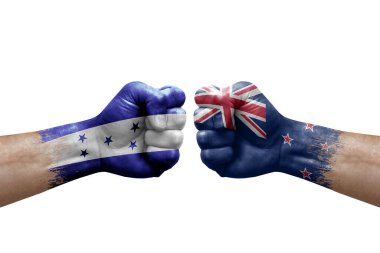 Two hands punch to each others on white background. Country flags painted fists, conflict crisis concept between honduras and new zealand
