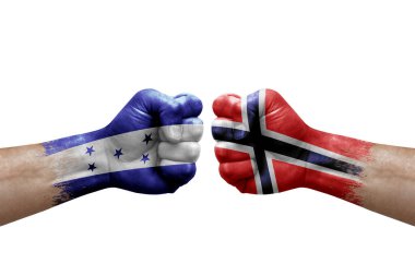 Two hands punch to each others on white background. Country flags painted fists, conflict crisis concept between honduras and norway