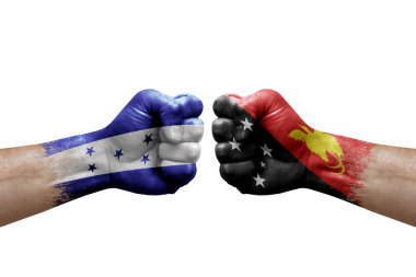 Two hands punch to each others on white background. Country flags painted fists, conflict crisis concept between honduras and papua new guinea