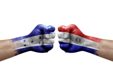 Two hands punch to each others on white background. Country flags painted fists, conflict crisis concept between honduras and paraguay