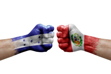 Two hands punch to each others on white background. Country flags painted fists, conflict crisis concept between honduras and peru