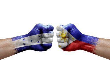 Two hands punch to each others on white background. Country flags painted fists, conflict crisis concept between honduras and philippines