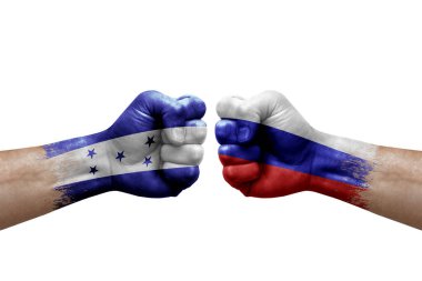 Two hands punch to each others on white background. Country flags painted fists, conflict crisis concept between honduras and russia