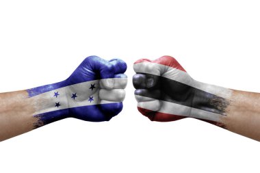 Two hands punch to each others on white background. Country flags painted fists, conflict crisis concept between honduras and thailand