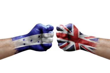 Two hands punch to each others on white background. Country flags painted fists, conflict crisis concept between honduras and united kingdom