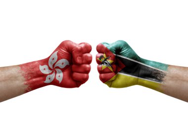Two hands punch to each others on white background. Country flags painted fists, conflict crisis concept between hong kong and mozambique