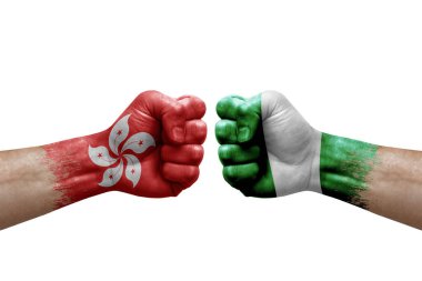 Two hands punch to each others on white background. Country flags painted fists, conflict crisis concept between hong kong and nigeria
