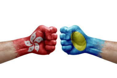 Two hands punch to each others on white background. Country flags painted fists, conflict crisis concept between hong kong and palau