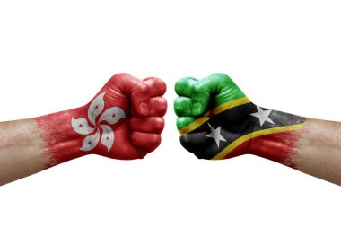 Two hands punch to each others on white background. Country flags painted fists, conflict crisis concept between hong kong and saint kitts and nevis