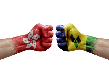 Two hands punch to each others on white background. Country flags painted fists, conflict crisis concept between hong kong and saint vincent and the grenadines