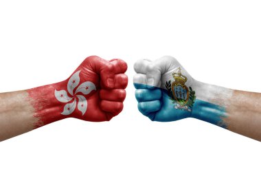 Two hands punch to each others on white background. Country flags painted fists, conflict crisis concept between hong kong and san marino